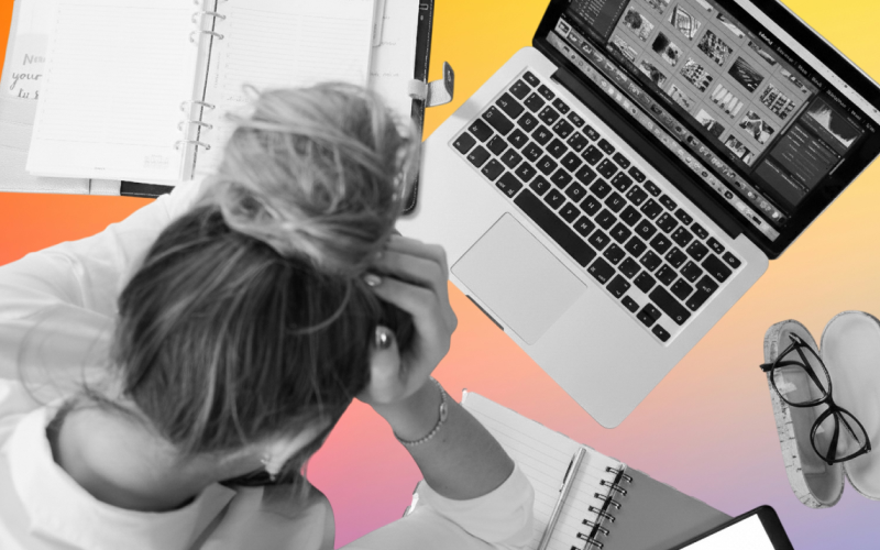 Person overwhelmed working at laptop